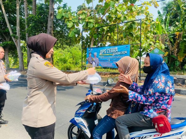 Kapolsek Sedati Beserta Jajaran Bagikan Nasi Kepada Pengendara Sepeda Motor